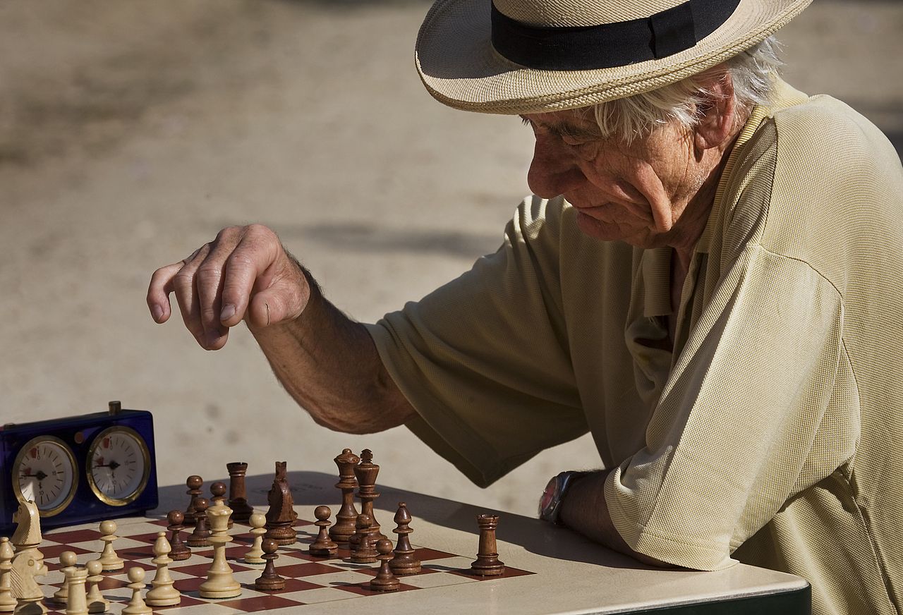 Old man playing timed chess